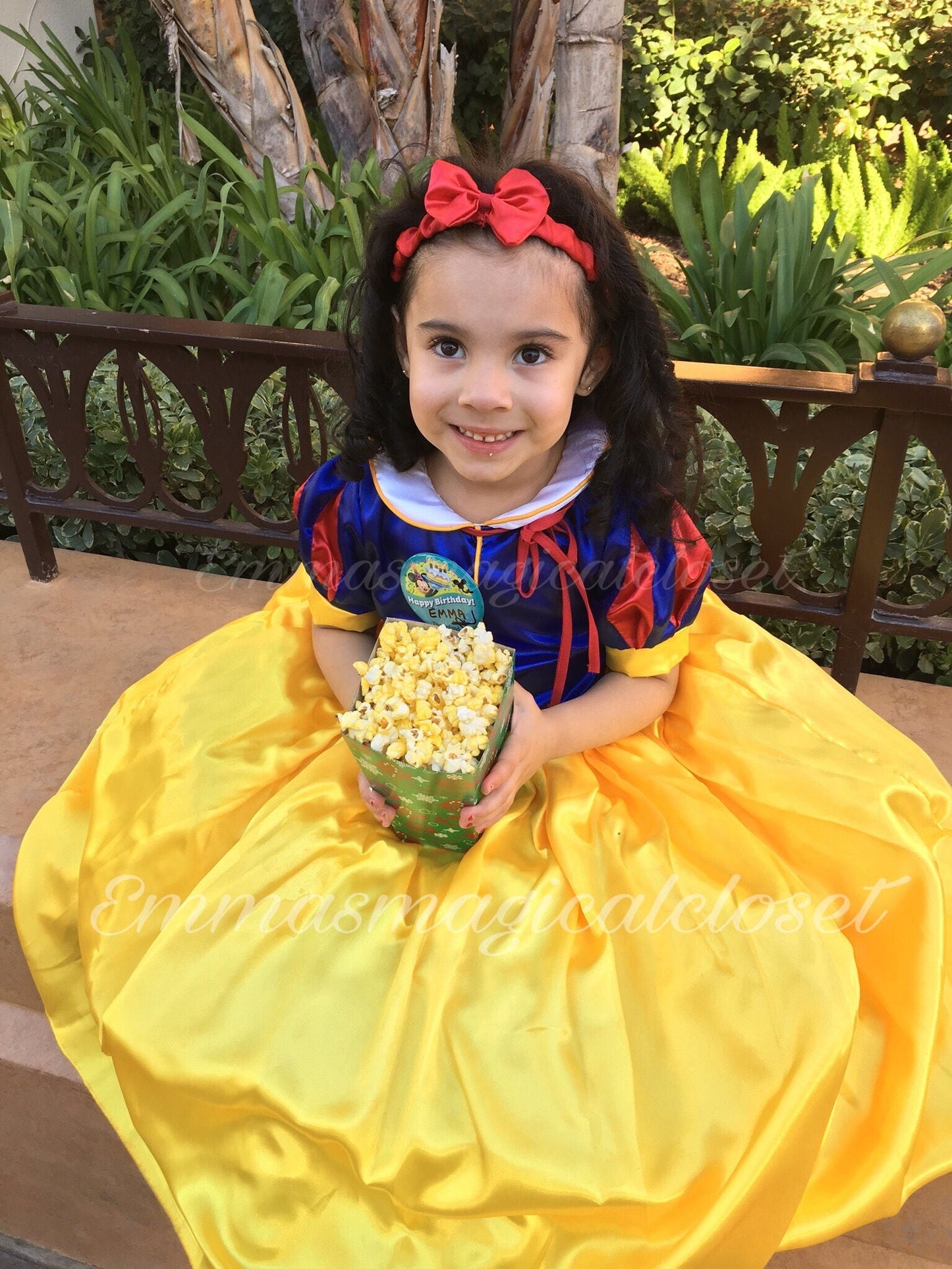 Fairest princess dress from Emma's Magical Dream eating popcorn, red headband included with white collar